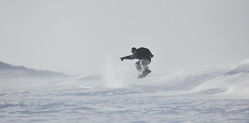 Image showing freestyle snowboarder jump and ride