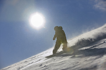 Image showing freestyle snowboarder jump and ride