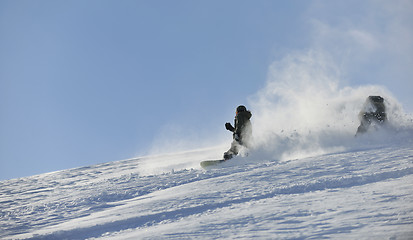 Image showing freestyle snowboarder jump and ride