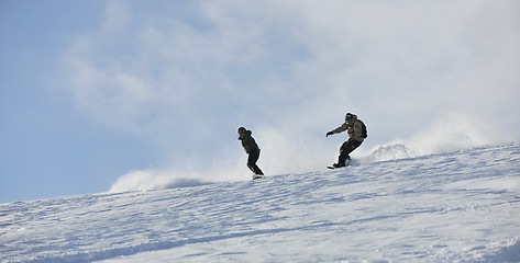 Image showing freestyle snowboarder jump and ride