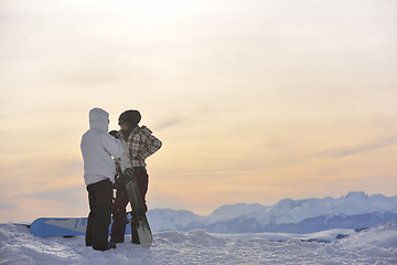 Image showing snowboarder's couple on mountain's top