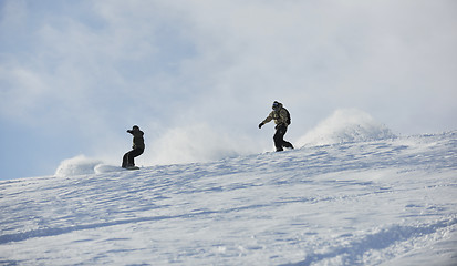 Image showing freestyle snowboarder jump and ride