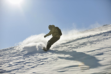 Image showing freestyle snowboarder jump and ride