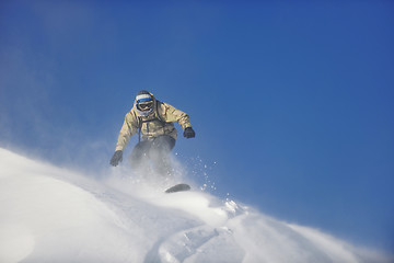 Image showing freestyle snowboarder jump and ride