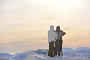 Image showing snowboarder's couple on mountain's top