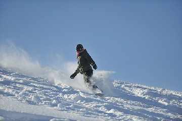 Image showing freestyle snowboarder jump and ride