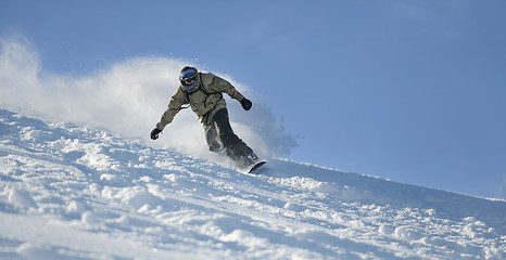 Image showing freestyle snowboarder jump and ride