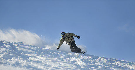 Image showing freestyle snowboarder jump and ride