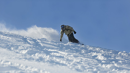 Image showing freestyle snowboarder jump and ride