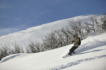 Image showing freestyle snowboarder jump and ride