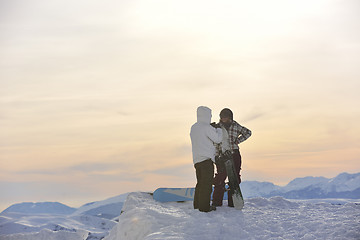 Image showing snowboarder's couple on mountain's top