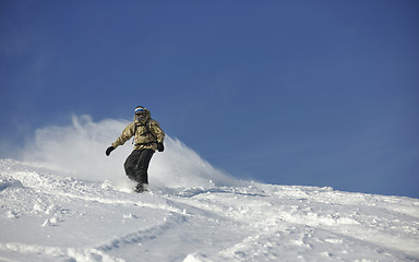 Image showing freestyle snowboarder jump and ride