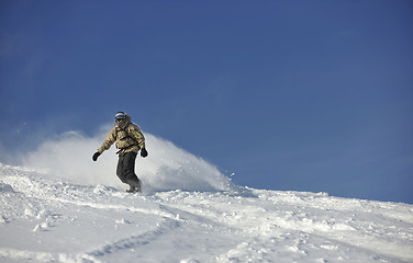 Image showing freestyle snowboarder jump and ride