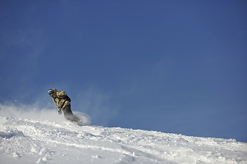 Image showing freestyle snowboarder jump and ride