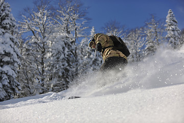 Image showing freestyle snowboarder jump and ride