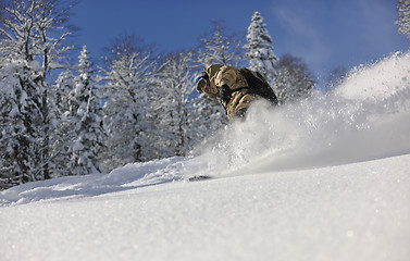 Image showing freestyle snowboarder jump and ride