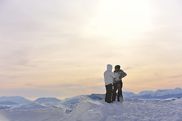 Image showing snowboarder's couple on mountain's top