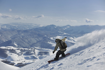 Image showing freestyle snowboarder jump and ride