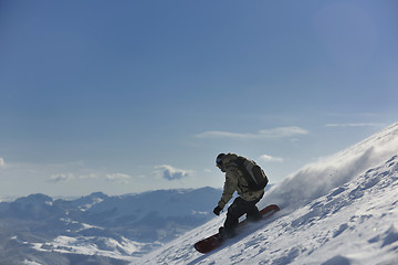 Image showing freestyle snowboarder jump and ride