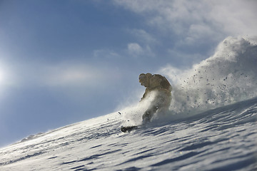 Image showing freestyle snowboarder jump and ride