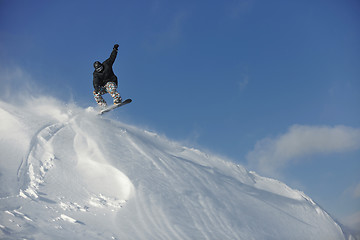 Image showing freestyle snowboarder jump and ride