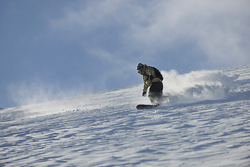 Image showing freestyle snowboarder jump and ride