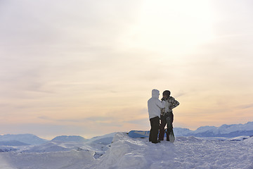 Image showing snowboarder's couple on mountain's top