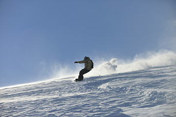 Image showing freestyle snowboarder jump and ride