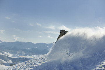 Image showing freestyle snowboarder jump and ride