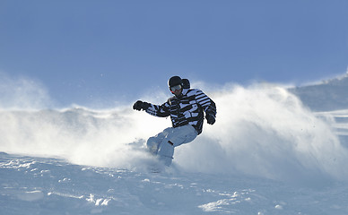 Image showing freestyle snowboarder jump and ride