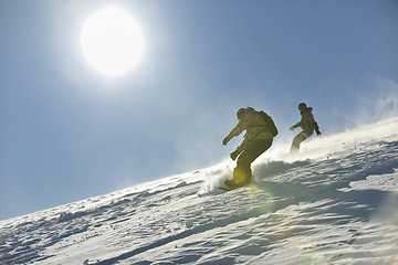 Image showing freestyle snowboarder jump and ride