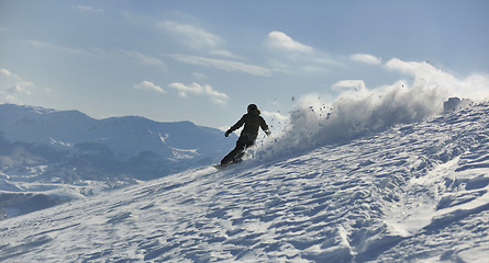 Image showing freestyle snowboarder jump and ride