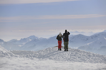 Image showing snowboarder's couple on mountain's top