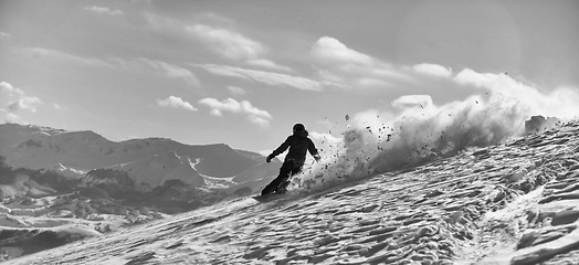 Image showing freestyle snowboarder jump and ride