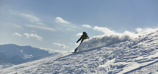 Image showing freestyle snowboarder jump and ride