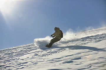 Image showing freestyle snowboarder jump and ride