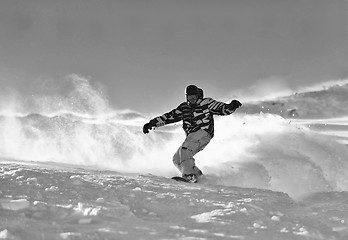 Image showing freestyle snowboarder jump and ride