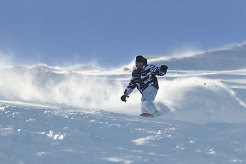 Image showing freestyle snowboarder jump and ride