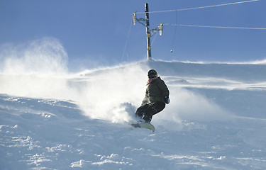 Image showing freestyle snowboarder jump and ride