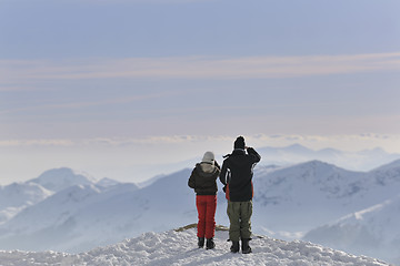 Image showing snowboarder's couple on mountain's top