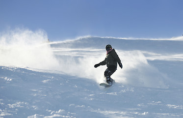 Image showing freestyle snowboarder jump and ride