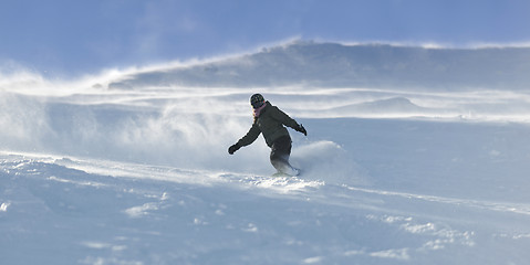 Image showing freestyle snowboarder jump and ride