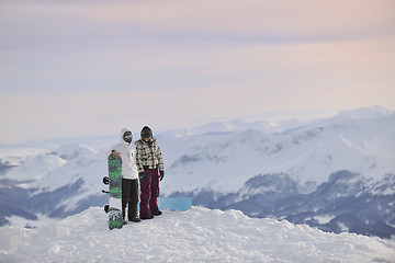 Image showing snowboarder's couple on mountain's top