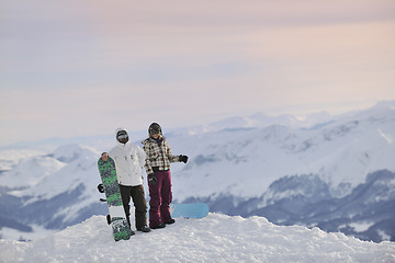 Image showing snowboarder's couple on mountain's top