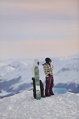 Image showing snowboarder's couple on mountain's top