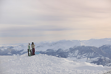 Image showing snowboarder's couple on mountain's top