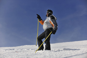 Image showing young skier relaxing at beautiful sunny winter day