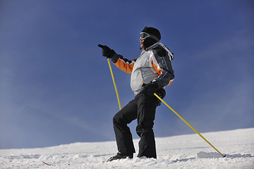 Image showing young skier relaxing at beautiful sunny winter day