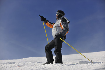 Image showing young skier relaxing at beautiful sunny winter day