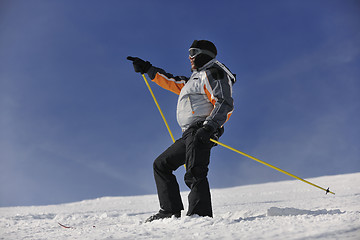 Image showing young skier relaxing at beautiful sunny winter day